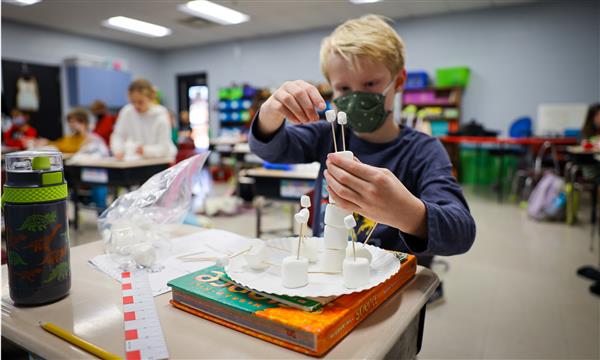 Boy builds marshmallow tower